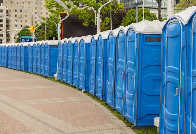 hygienic portable restrooms lined up at a music festival, providing comfort and convenience for attendees in Bay Harbor Islands